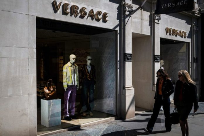 MILAN — The Prada Group announced Tuesday that it has officially purchased Milan fashion rival Versace in a 1.25 billion euro (nearly $1.4 billion) deal that puts the fashion house known for its sexy silhouettes under the same roof as Prada’s “ugly chic” aesthetic and Miu Miu’s youth-driven appeal.
The highly anticipated deal is expected to relaunch Versace’s fortunes, after middling post-pandemic performance as part of the U.S. luxury group Capri Holdings.
Prada said in a one-line statement that the acquisition had been completed after receiving all regulatory clearances.
Prada heir Lorenzo Bertelli will steer Versace’s next phase as executive chairman, in addition to his roles as group marketing director and sustainability chief.
The son of co-creative director Miuccia Prada and longtime Prada Group chairman Patrizio Bertelli has said he doesn’t expect to make any swift executive changes at Versace. But Bertelli has said that the company, which places among the top 10 most recognized brands in the world, has long been underperforming in the market.
Prada has underlined that the 47-year-old Versace brand offered “significant untapped growth potential.’’
Versace has been in the midst of a creative relaunch under a new designer, Dario Vitale, who previewed his first collection during Milan Fashion Week in September. He had previously been head of design at Miu Miu, but his move to Versace was unrelated to the Prada deal, executives have said.
Capri Holdings, which owns Michael Kors and Jimmy Choo, paid $2 billion for Versace in 2018, but had been struggling to position Versace’s bold profile in the recent era of “quiet luxury.″
Versace represented 20% of Capri Holdings 2024 revenue of 5.2 billion euros. An analyst presentation for the Prada deal said that Versace would represent 13% of the Prada Group’s pro-forma revenues, with Miu Miu coming in at 22% and Prada at 64%. The Prada Group, which also includes Church’s footwear, reported a 17% boost in revenues to 5.4 billion euros last year.
The Prada Group has already begun preparations to incorporate crosstown rival Versace into its Italian manufacturing system, a point of pride for the group.
“Making a bag for one brand or another, the know-how is the same,″ Bertelli told reporters last week at the group’s Scandicci leather goods factory, which already makes bags for the Prada and Miu Miu brands and will soon add Versace.
The Prada Group’s has invested 60 million euros in its supply chain this year, including a new leather goods factory near Siena, a new knitwear factory near Perugia as well as increasing production at its factory Church’s footwear factory in Britain and expanding another Tuscan factory. That’s on top of 200 million euros in investments from 2019-24.
Prada’s efforts include an academy that has trained some 570 new artisans over the last 25 years in an in-house training academy operating in the Tuscany, Marche, Veneto and Umbria regions.
Last year, Prada hired 70% of the 120 artisans who trained in the academy. The number of trainees rose by 28% to 152 this year.
This post appeared first on NBC NEWS